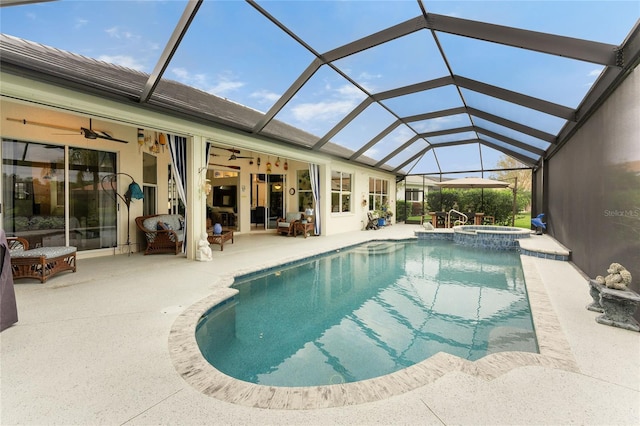 view of swimming pool with ceiling fan, a lanai, an in ground hot tub, and a patio