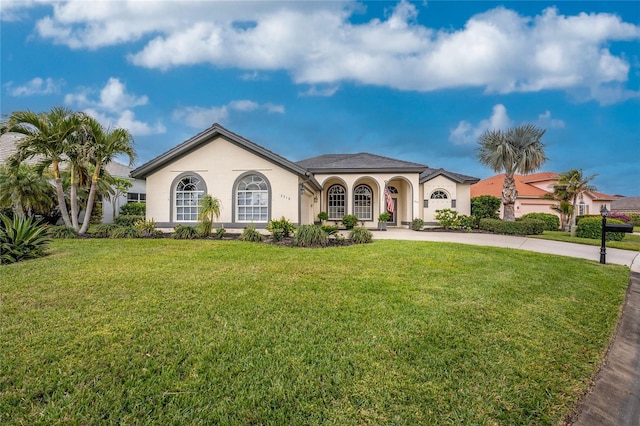 mediterranean / spanish house featuring a front lawn