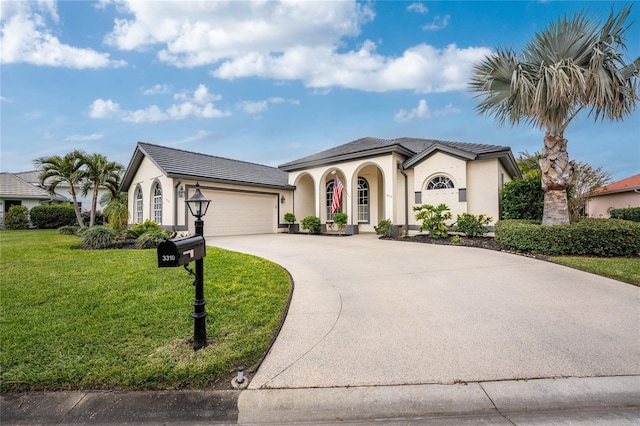 mediterranean / spanish home featuring a garage and a front lawn