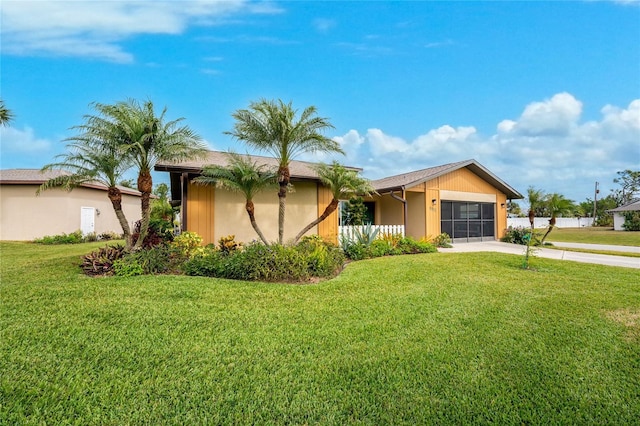 ranch-style house with a garage and a front yard