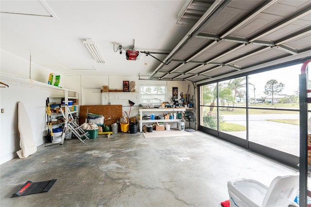 garage with a garage door opener and a workshop area