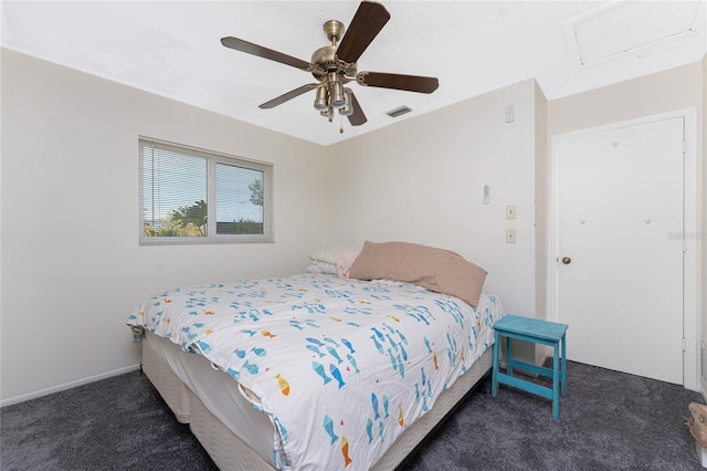 bedroom with ceiling fan and dark carpet