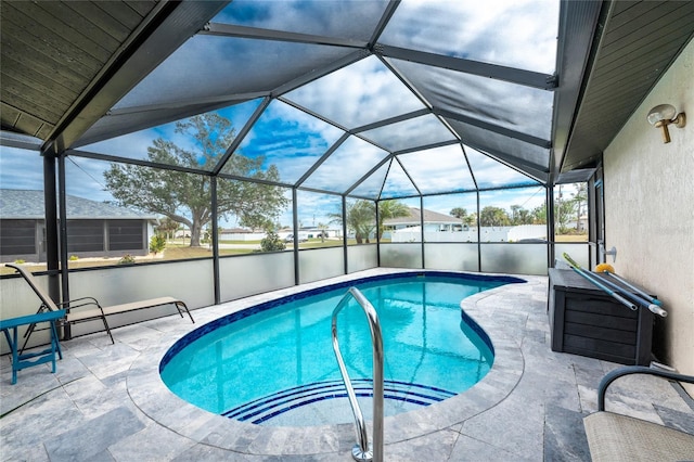 view of swimming pool featuring a patio and glass enclosure