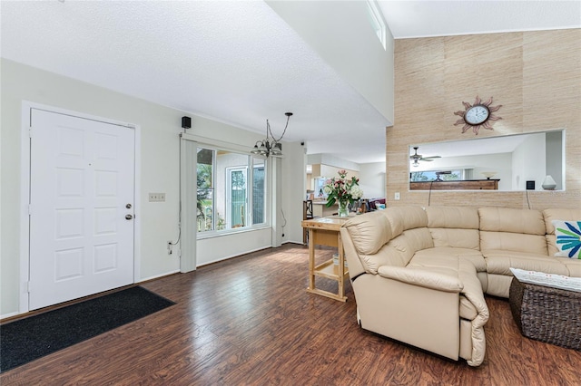 living room with ceiling fan, dark hardwood / wood-style floors, and a textured ceiling