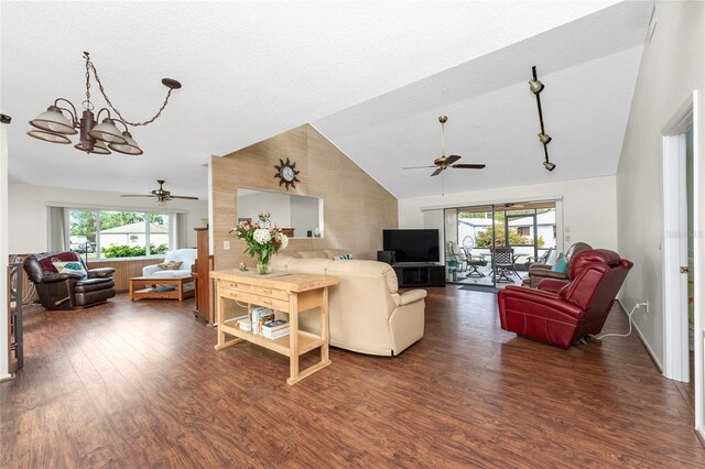 living room with dark hardwood / wood-style floors, ceiling fan with notable chandelier, and a wealth of natural light