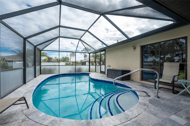 view of pool featuring a patio area and glass enclosure