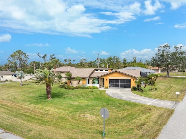 view of front facade featuring a sunroom, a front yard, concrete driveway, and an attached garage