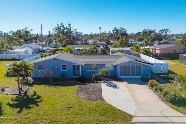 ranch-style home featuring a front lawn and a garage