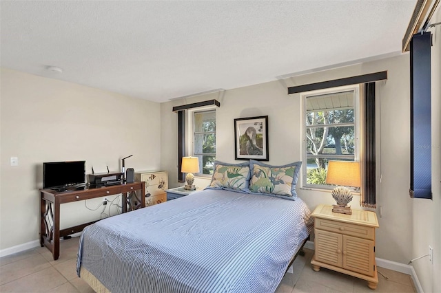 bedroom featuring light tile patterned flooring and a textured ceiling