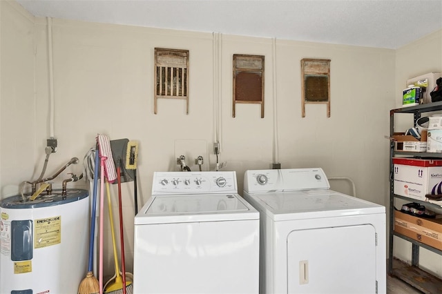 washroom featuring electric water heater and separate washer and dryer