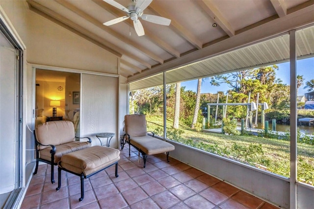 sunroom / solarium with ceiling fan, a healthy amount of sunlight, and lofted ceiling