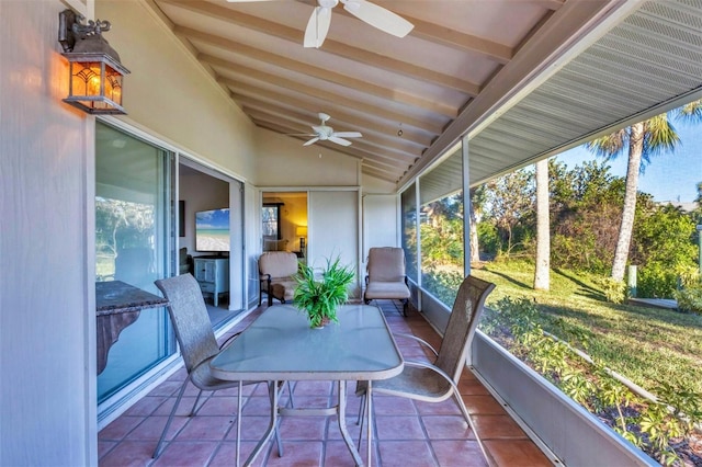 sunroom with ceiling fan and vaulted ceiling