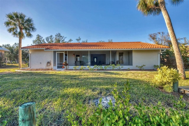 view of front of property featuring a sunroom and a front yard