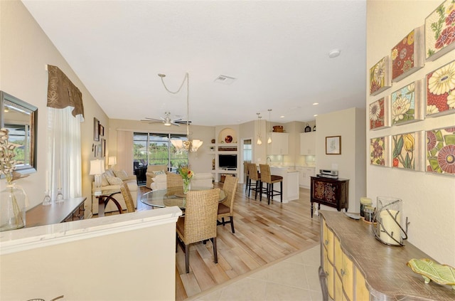 tiled living room with ceiling fan