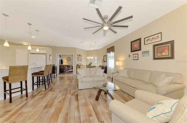 living room with ceiling fan and light wood-type flooring