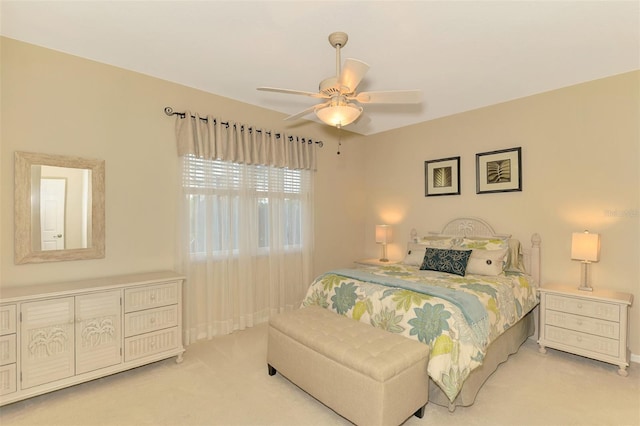 bedroom with light carpet and ceiling fan