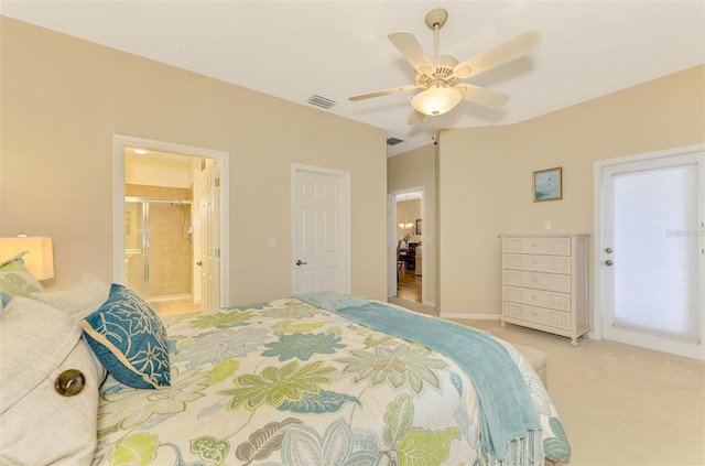 carpeted bedroom with ensuite bathroom and ceiling fan