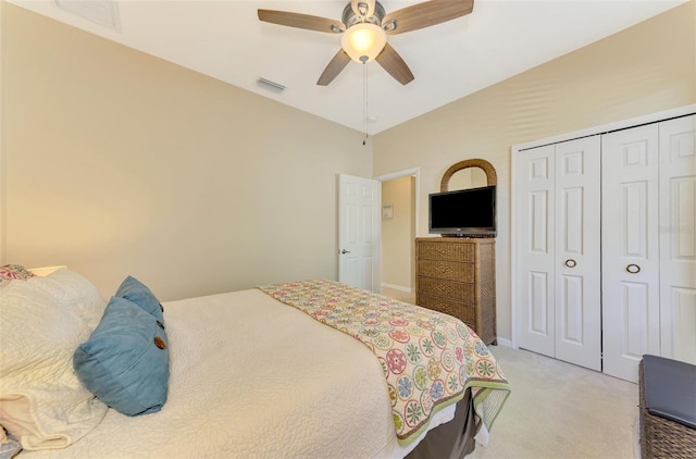 bedroom featuring ceiling fan, lofted ceiling, light carpet, and a closet