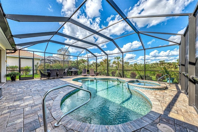 view of pool featuring an in ground hot tub, a patio, and glass enclosure