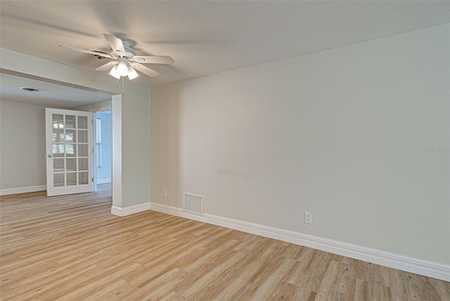 spare room with ceiling fan and light wood-type flooring