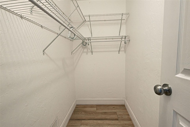 walk in closet featuring hardwood / wood-style flooring