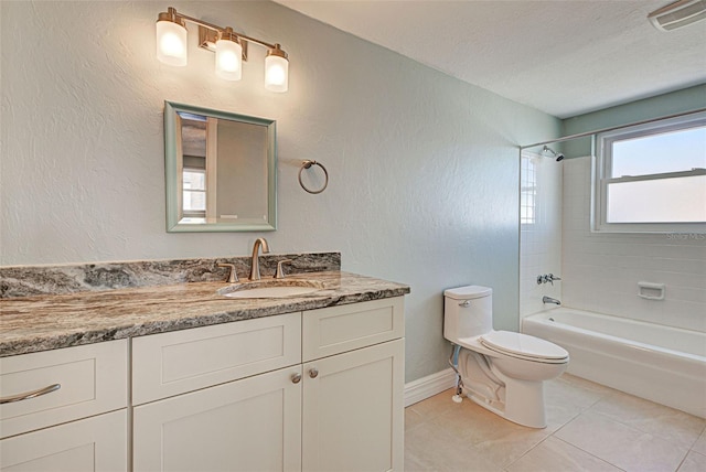 full bathroom featuring vanity, tiled shower / bath, tile patterned flooring, toilet, and a textured ceiling