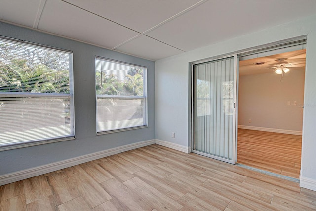 empty room with light hardwood / wood-style flooring and ceiling fan