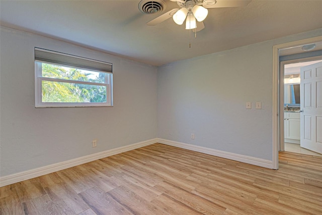 spare room featuring light hardwood / wood-style floors and ceiling fan