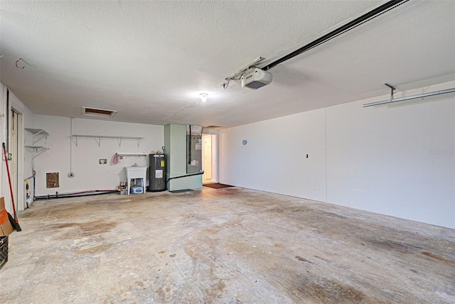 garage featuring electric water heater, sink, and a garage door opener