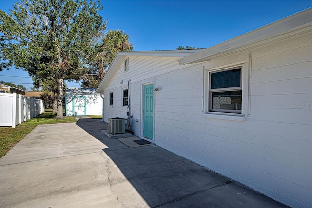 view of side of property featuring a patio area and central AC