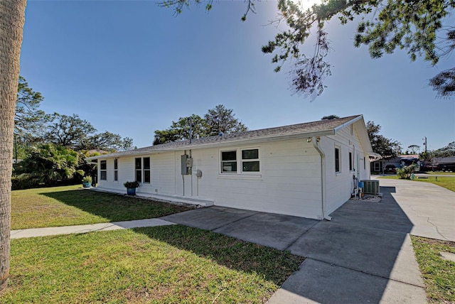 single story home with a patio, central AC, and a front lawn