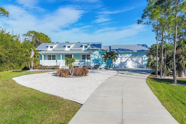 view of front of house with a front lawn, a porch, and a garage