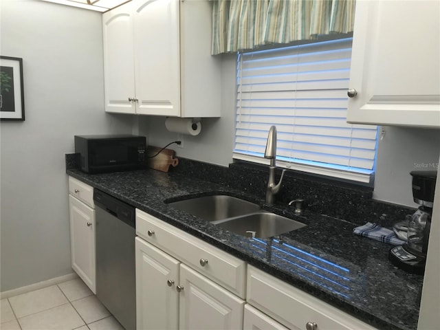 kitchen featuring white cabinetry, sink, light tile patterned floors, and stainless steel dishwasher