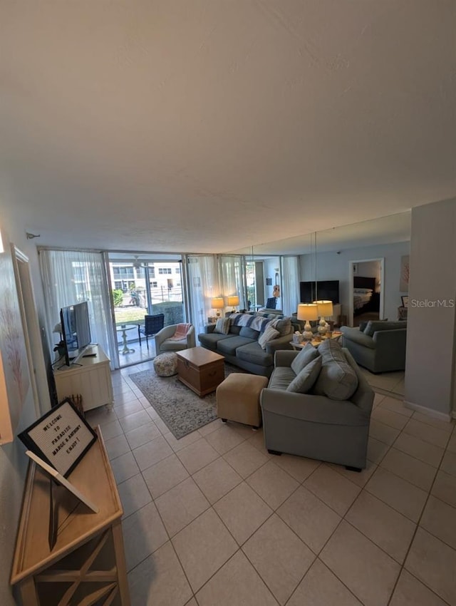 living room with light tile patterned floors and floor to ceiling windows