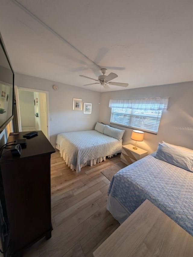 bedroom with hardwood / wood-style floors and ceiling fan