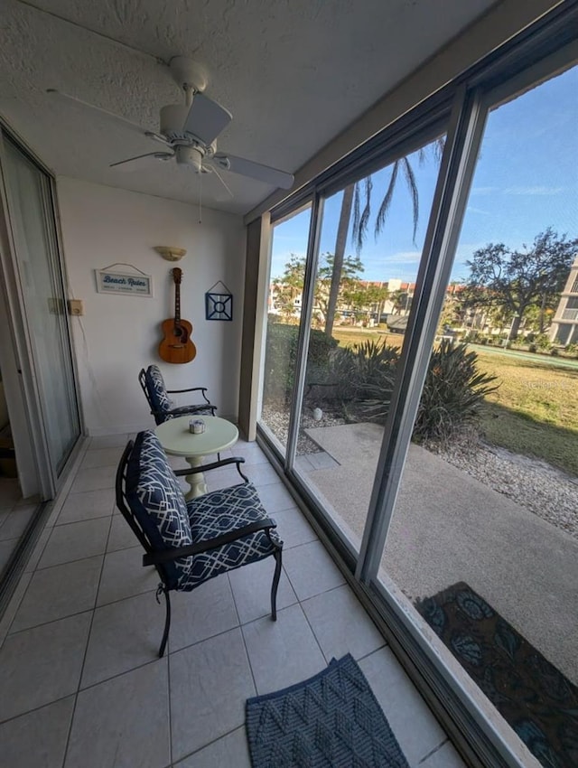 sunroom / solarium featuring ceiling fan