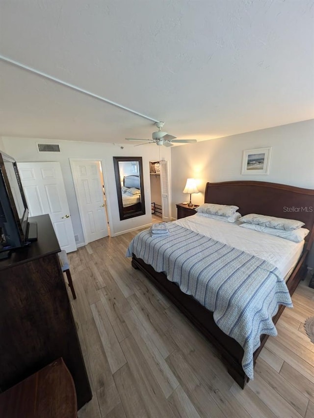 bedroom featuring ceiling fan and light hardwood / wood-style flooring