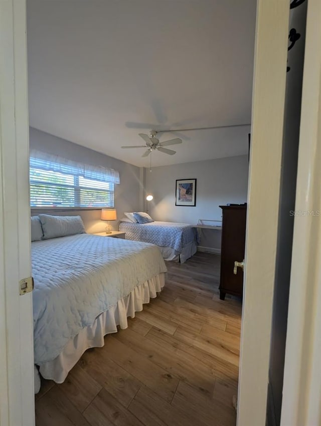 bedroom featuring ceiling fan and hardwood / wood-style flooring