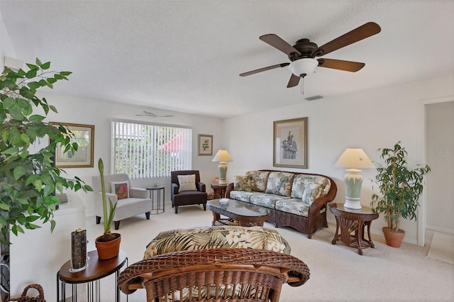 carpeted living room with ceiling fan