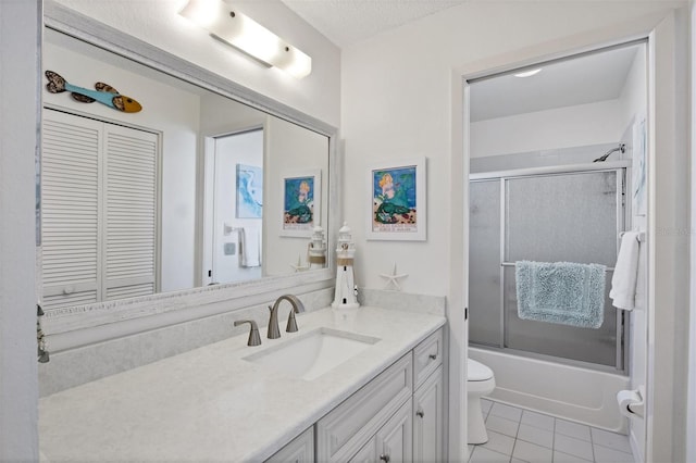 full bathroom with vanity, tile patterned flooring, toilet, enclosed tub / shower combo, and a textured ceiling