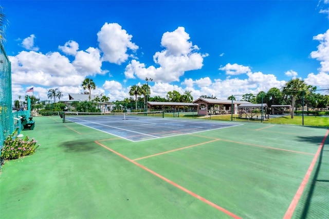 view of tennis court featuring basketball court