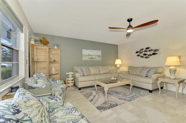 living room featuring a textured ceiling, a wealth of natural light, and ceiling fan