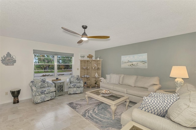 living room with ceiling fan and a textured ceiling