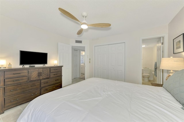 bedroom with ceiling fan, a closet, and ensuite bath