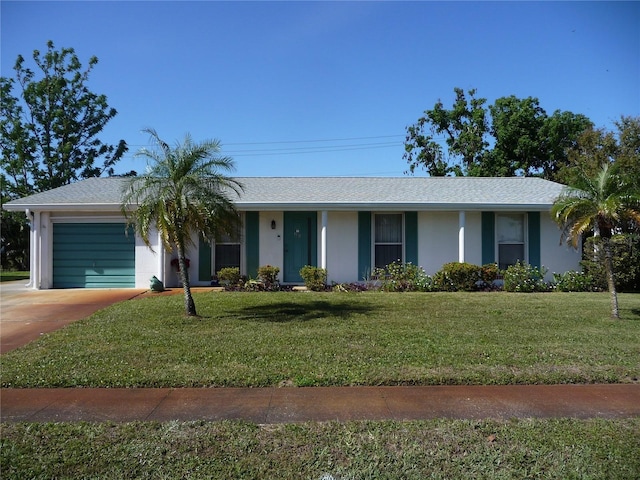 ranch-style house featuring a front yard and a garage