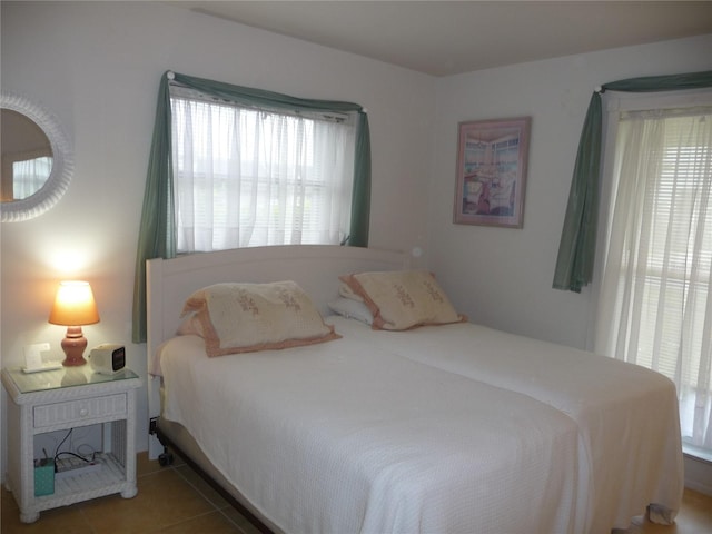 tiled bedroom featuring multiple windows