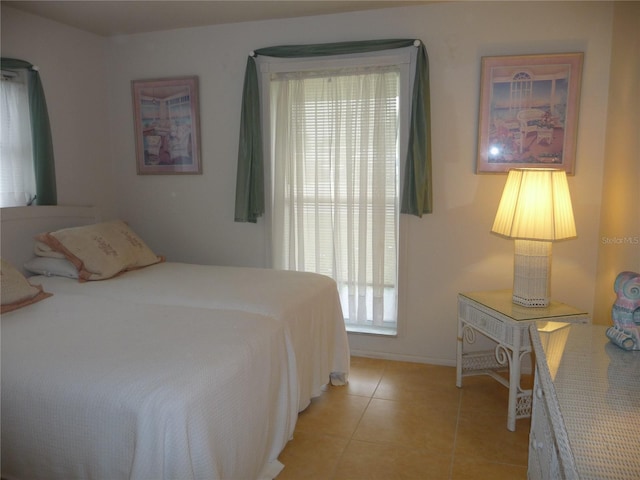 bedroom with light tile patterned floors