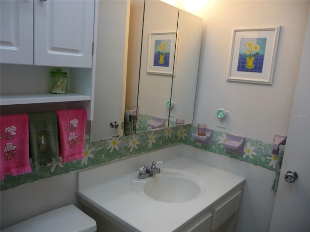 bathroom with vanity and toilet