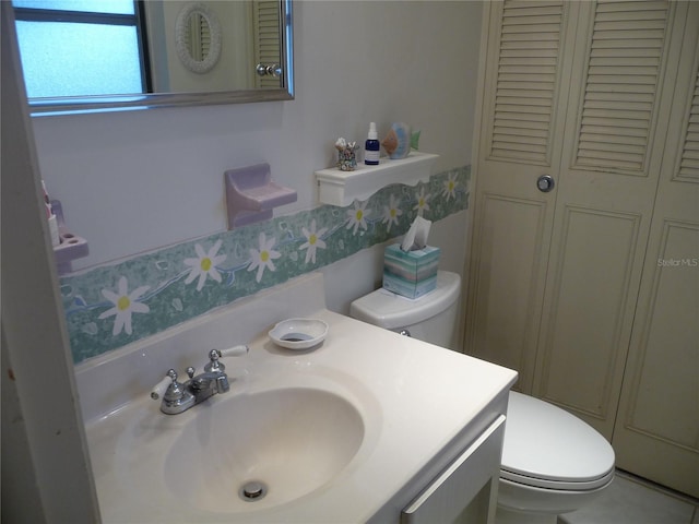 bathroom featuring vanity and toilet