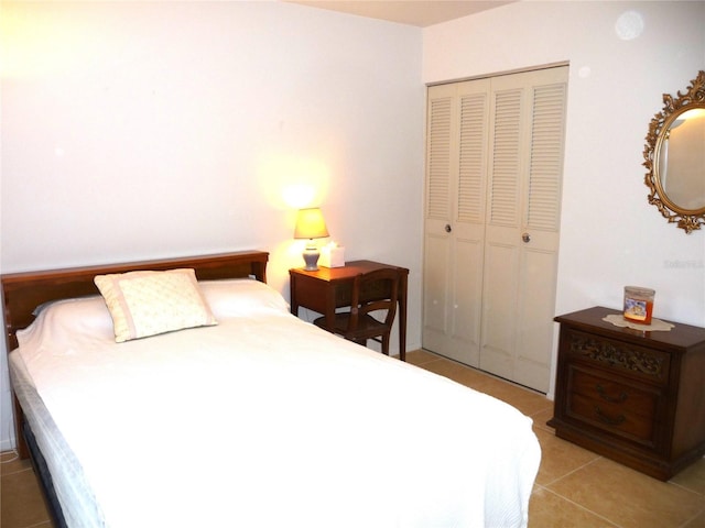 tiled bedroom featuring a closet